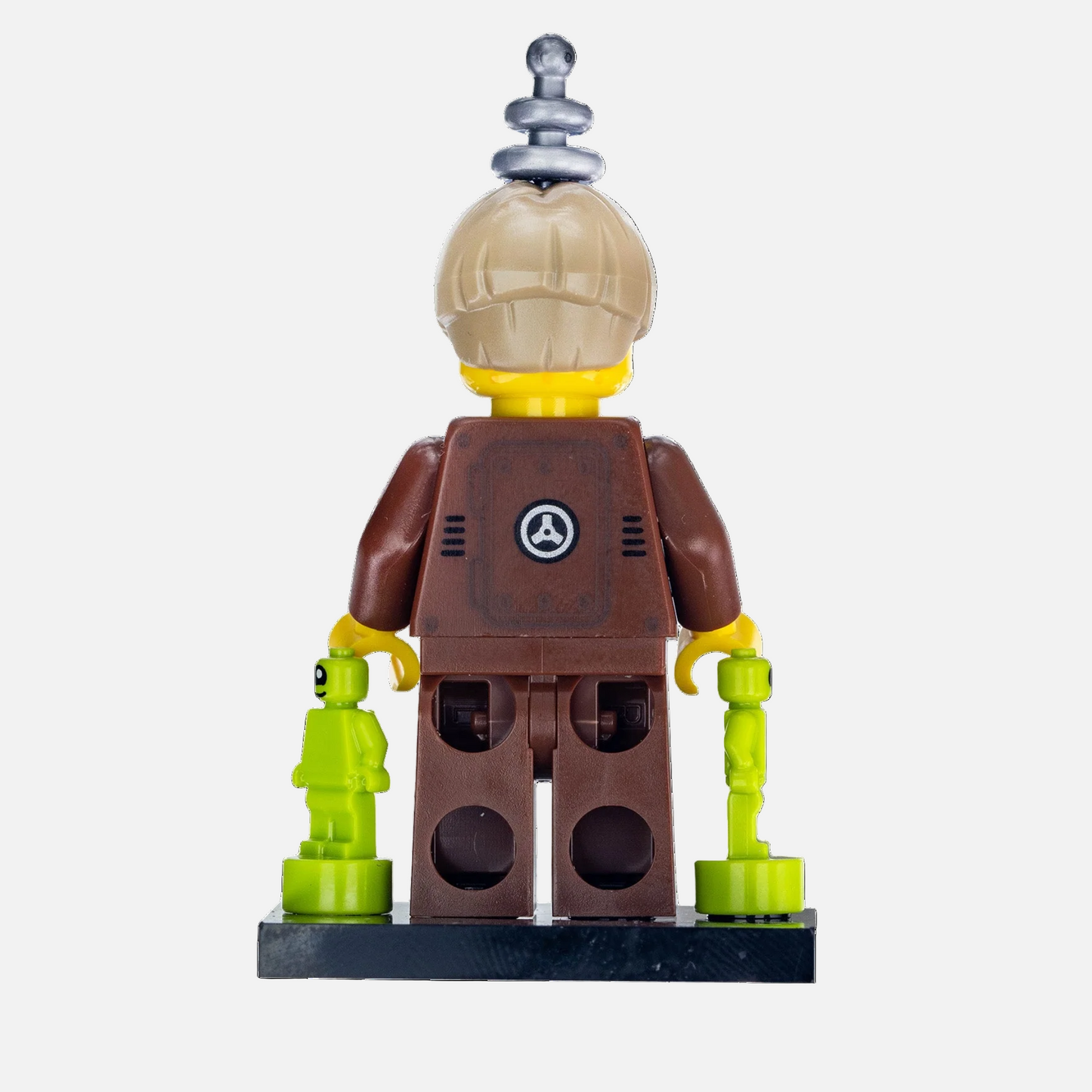 Toy figure with a brown outfit and helmet, holding a smaller green figure on a white background