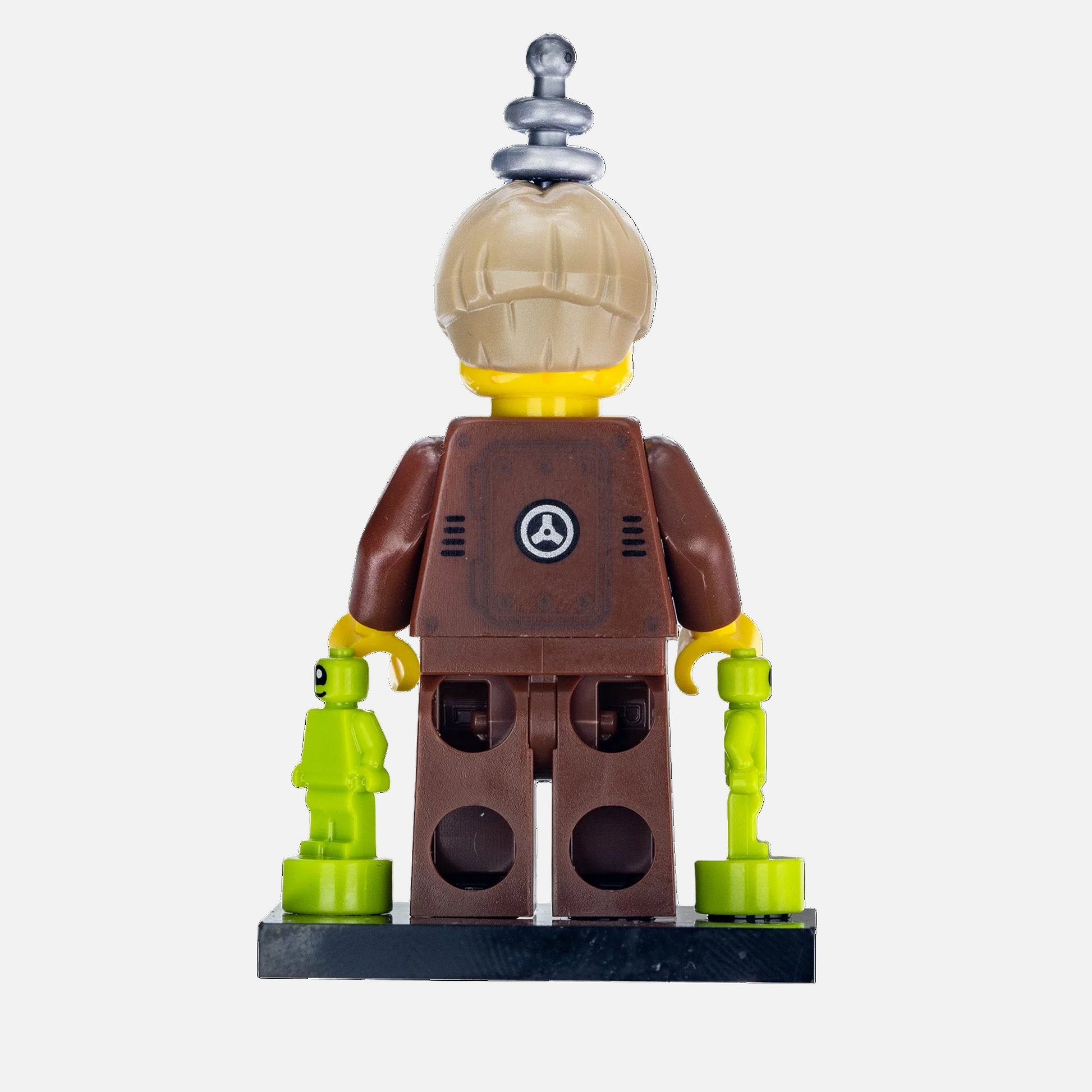 Toy figure with a brown outfit and helmet, holding a smaller green figure on a white background